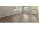 Bright bedroom features wood-look flooring, neutral walls, and natural light from two windows at 6432 Zephyr St, Arvada, CO 80004