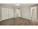 Cozy bedroom with wood-look flooring, closet, and easy access to en suite bathroom at 6432 Zephyr St, Arvada, CO 80004