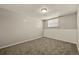 Neutral-colored bedroom featuring carpeting and a single window at 6432 Zephyr St, Arvada, CO 80004