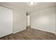 Neutral bedroom featuring wood-look flooring, closet, and neutral walls at 6432 Zephyr St, Arvada, CO 80004