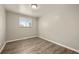 Bright bedroom boasts natural light, wood-look floors, and neutral paint at 6432 Zephyr St, Arvada, CO 80004