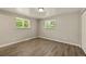 Bright bedroom with wood-look flooring and windows offering abundant natural light at 6432 Zephyr St, Arvada, CO 80004