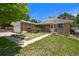 Charming single-Gathering home with brick exterior, a two-car garage, and attractive landscaping at 6432 Zephyr St, Arvada, CO 80004