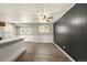 Spacious room featuring modern flooring, neutral walls, and a ceiling fan at 6432 Zephyr St, Arvada, CO 80004