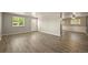 Inviting living room with wood-look floors and abundant natural light from large windows at 6432 Zephyr St, Arvada, CO 80004