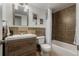This bathroom is complete with warm tile, updated vanity and fixtures, and bathtub with shower at 1121 Albion St # 809, Denver, CO 80220