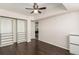 Minimalist bedroom featuring dark hardwood floors, closet organizer, and a ceiling fan at 1121 Albion St # 809, Denver, CO 80220