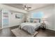 Cozy bedroom with a ceiling fan, a large window, and an ensuite bathroom at 1121 Albion St # 809, Denver, CO 80220