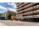Exterior building shot showing multiple floors with EV chargers and parking garage on the side at 1121 Albion St # 809, Denver, CO 80220