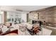 Spacious living room featuring a wood accent wall and a sliding door to a balcony at 1121 Albion St # 809, Denver, CO 80220