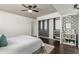 Bright bedroom with hardwood floors, a modern closet system, and stylish wallpaper at 1121 Albion St # 809, Denver, CO 80220