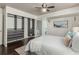 Stylish bedroom with hardwood floors, a ceiling fan, and a well-organized closet system at 1121 Albion St # 809, Denver, CO 80220