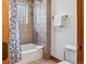 Well-lit bathroom with a shower-tub combination, tiled walls, and modern fixtures at 180 Emmett Lode Rd, Breckenridge, CO 80424