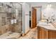 Bathroom with double sink vanity, stone-tile shower and walk-in closet at 180 Emmett Lode Rd, Breckenridge, CO 80424