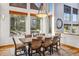 Elegant dining room featuring a large rustic table, comfortable seating, and expansive windows with scenic views at 180 Emmett Lode Rd, Breckenridge, CO 80424