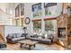 Inviting living room with a stone fireplace, large windows for natural light, and comfortable seating arrangement at 180 Emmett Lode Rd, Breckenridge, CO 80424
