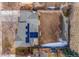 Aerial view of the house featuring a gray roof with solar panels and large fenced backyard at 7310 S Sheridan Ct, Littleton, CO 80128