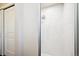 Bright bathroom with large sliding glass shower door and large white tiles at 7310 S Sheridan Ct, Littleton, CO 80128