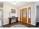 Inviting foyer features wood-look flooring and a decorative front door, complemented by a stylish table and decor at 7310 S Sheridan Ct, Littleton, CO 80128