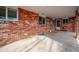Covered patio area with brick columns and walls overlooking a spacious backyard at 7310 S Sheridan Ct, Littleton, CO 80128