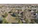 Aerial view showcases a sprawling estate with mature trees and landscaping, complete with a long private driveway at 15935 W 77Th Pl, Arvada, CO 80007