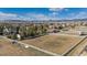 Aerial view showcases a sprawling property with fenced pastures, offering a serene countryside setting at 15935 W 77Th Pl, Arvada, CO 80007