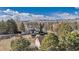 Aerial view featuring a lovely two story home surrounded by mature landscaping and white fencing at 15935 W 77Th Pl, Arvada, CO 80007