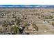 Vast community aerial view with homes surrounded by white-fenced yards at 15935 W 77Th Pl, Arvada, CO 80007