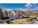 This backyard features a well-kept lawn, mature trees, and privacy fencing for outdoor enjoyment at 15935 W 77Th Pl, Arvada, CO 80007