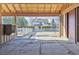 View from barn interior looking out towards a white two story home with a white fence at 15935 W 77Th Pl, Arvada, CO 80007