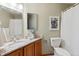 Cozy bathroom with a vanity, granite countertop, neutral walls, and toilet with a white shower curtain at 15935 W 77Th Pl, Arvada, CO 80007