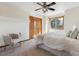 Bright bedroom featuring a ceiling fan, double closet, window with sunlight, and neutral decor at 15935 W 77Th Pl, Arvada, CO 80007