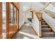 Bright and inviting entryway with high ceilings, wood floors and staircase at 15935 W 77Th Pl, Arvada, CO 80007