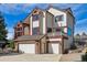 A charming home with a brick and siding facade, a two-car garage, and a professionally landscaped yard at 15935 W 77Th Pl, Arvada, CO 80007