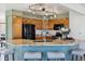 Modern kitchen featuring granite countertops, wooden cabinets and stainless steel appliances at 15935 W 77Th Pl, Arvada, CO 80007