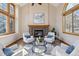 Inviting living room with fireplace and large windows providing ample natural light at 15935 W 77Th Pl, Arvada, CO 80007