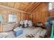 A wooden shed with a window, interior storage, and visible lumber at 15935 W 77Th Pl, Arvada, CO 80007
