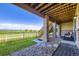 Covered patio with brick columns, outdoor seating, and scenic backyard views at 15975 Quandary Loop, Broomfield, CO 80023