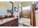Tiled bathroom with granite vanity, stylish fixtures, and tub-shower combination at 15975 Quandary Loop, Broomfield, CO 80023
