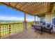 Covered deck with outdoor seating, stone columns, and scenic mountain views at 15975 Quandary Loop, Broomfield, CO 80023
