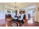 Open dining area with hardwood floors and a view to the kitchen and living room at 15975 Quandary Loop, Broomfield, CO 80023