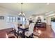 Elegant dining area with hardwood floors, modern lighting, and open to the living room at 15975 Quandary Loop, Broomfield, CO 80023