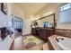 Spacious main bathroom with granite countertops, dual sinks, and a relaxing soaking tub at 15975 Quandary Loop, Broomfield, CO 80023