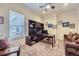 Cozy home office with built-in bookshelves, a ceiling fan, and a comfortable sofa at 15975 Quandary Loop, Broomfield, CO 80023