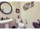 Stylish powder room with pedestal sink, round mirror, and elegant decor, offering convenience for guests at 15975 Quandary Loop, Broomfield, CO 80023