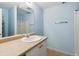 Bright bathroom featuring a single sink vanity with modern fixtures, and a shower at 7234 E 38Th Ave, Denver, CO 80207