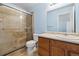 Bathroom with a glass shower, single sink vanity, and updated fixtures at 7234 E 38Th Ave, Denver, CO 80207