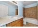 Well-maintained bathroom features tile accents, a tub, and a vanity with a sink at 7234 E 38Th Ave, Denver, CO 80207