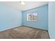 Cozy bedroom featuring fresh paint, neutral carpet, and a window for natural light at 7234 E 38Th Ave, Denver, CO 80207