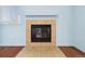 Close-up of a cozy fireplace with decorative tile surround in a naturally lit room at 7234 E 38Th Ave, Denver, CO 80207